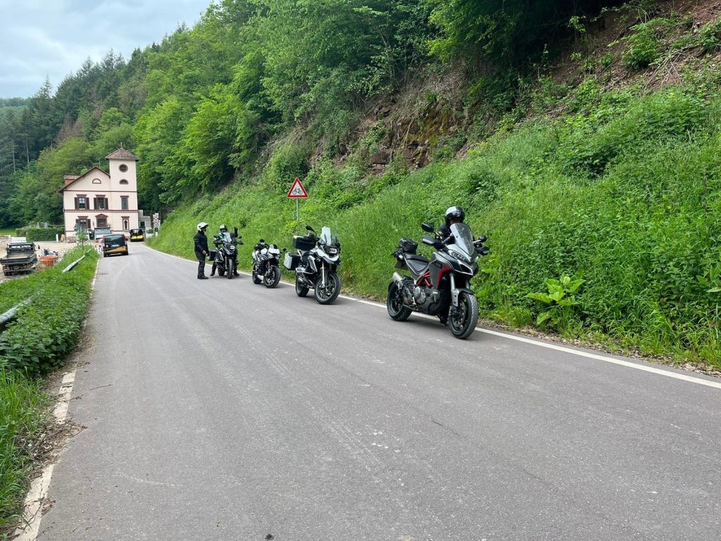 Group of motorcycles parked by the side of a road